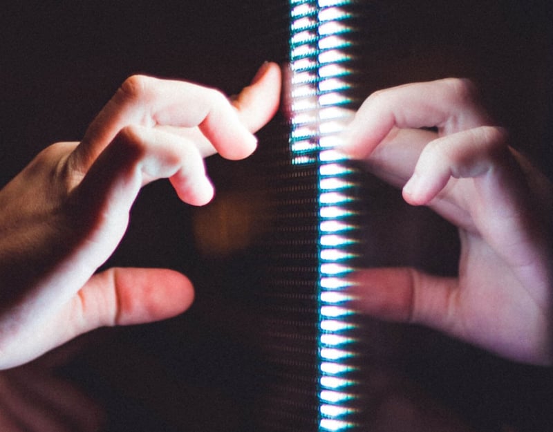 Hand touching a screen in the dark
