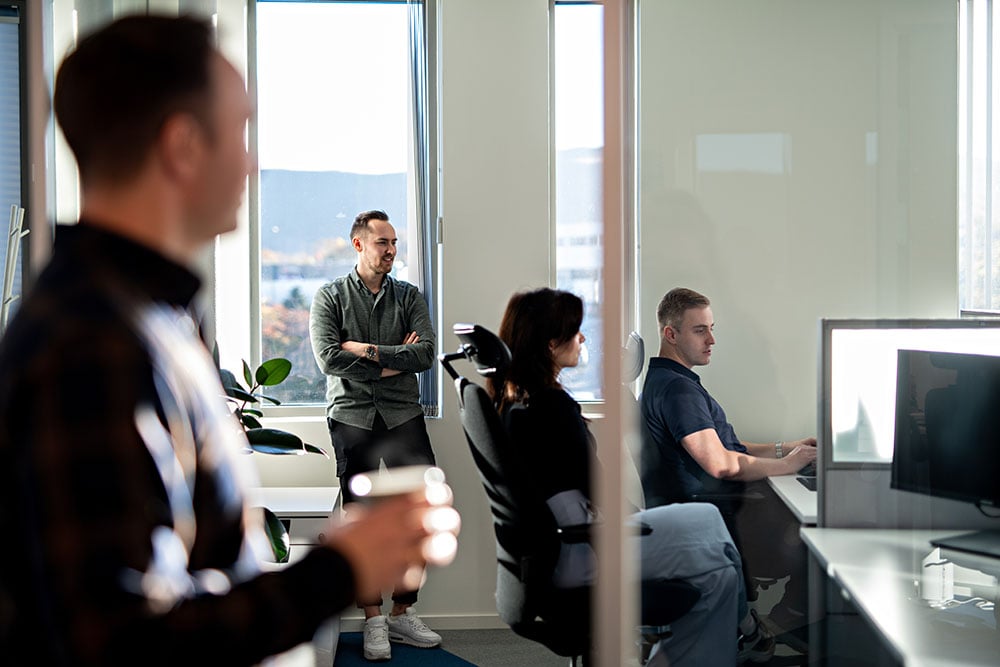 4 coworkers looking at pc -1000x
