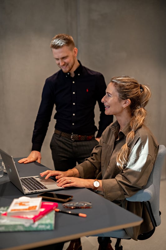 smiling and working on laptop -1500x